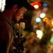 A Newtown resident who identified himself only as Andrew, holds roses as he visits a memorial for the Sandy Hook Elementary School shooting victims, Tuesday, Dec. 18, 2012, in Newtown, Conn. 