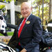 S. Truett Cathy, founder of Chick-fil-A, poses Thursday, Nov. 8, 2001, on his son, Dan T. Cathy's, Harley Davidson motorcycle which is painted to look like a cow, in front of the company's headquarters in south Atlanta. The seasoned, breaded chicken breast sandwich Cathy toyed with 55 years ago as a kitchen experiment has helped Chick-fil-A become the second-largest fast-food chicken restaurant in the U.S., with restaurants in 34 states and Washington D.C. (AP Photo/Ric Feld)