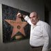 Don LaFontaine, a voice over actor, poses for a photo next to a Hollywood Walk of Fame look alike star given to him by his wife, in his recording studio in his Silver Lake home in Los Angeles Wednesday, Feb. 14, 2007. 