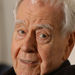 In this Feb. 18, 2004 file photo, playwright Horton Foote stands on the set of "The Traveling Lady" at Baylor University in Waco, Texas.