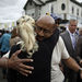 Philadelphia Mayor Michael Nutter, center right, hugs Lori Dee Patterson, a nearby resident, after she handed him a cup of coffee after he spoke at a news conference near the scene of a deadly train derailment, Wednesday, May 13, 2015, in Philadelphia. An Amtrak train headed to New York City derailed and crashed in Philadelphia on Tuesday night, killing at least six people and injuring dozens more. (AP Photo/Matt Slocum)